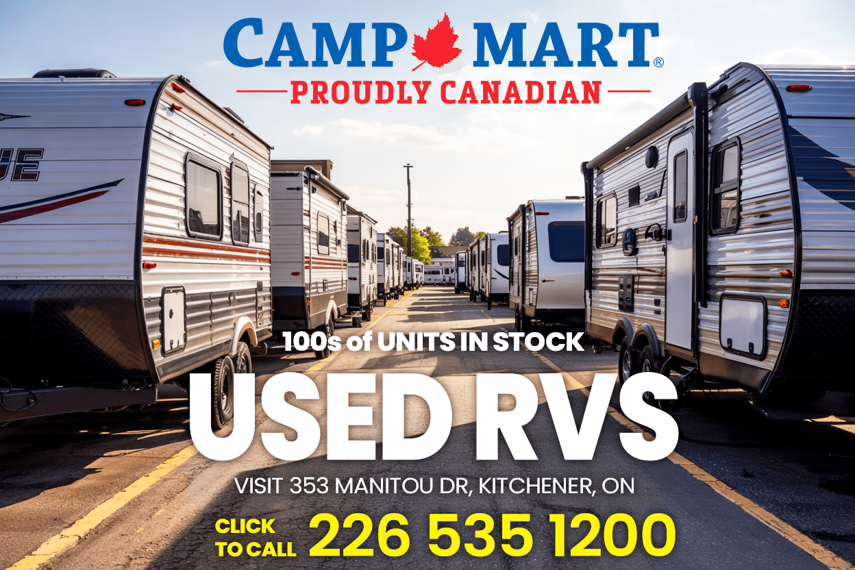Wide parking‑lot scene with three pre‑owned travel trailers front and center, rows of additional RVs stretching into the background at a Kitchener Ontario dealership.